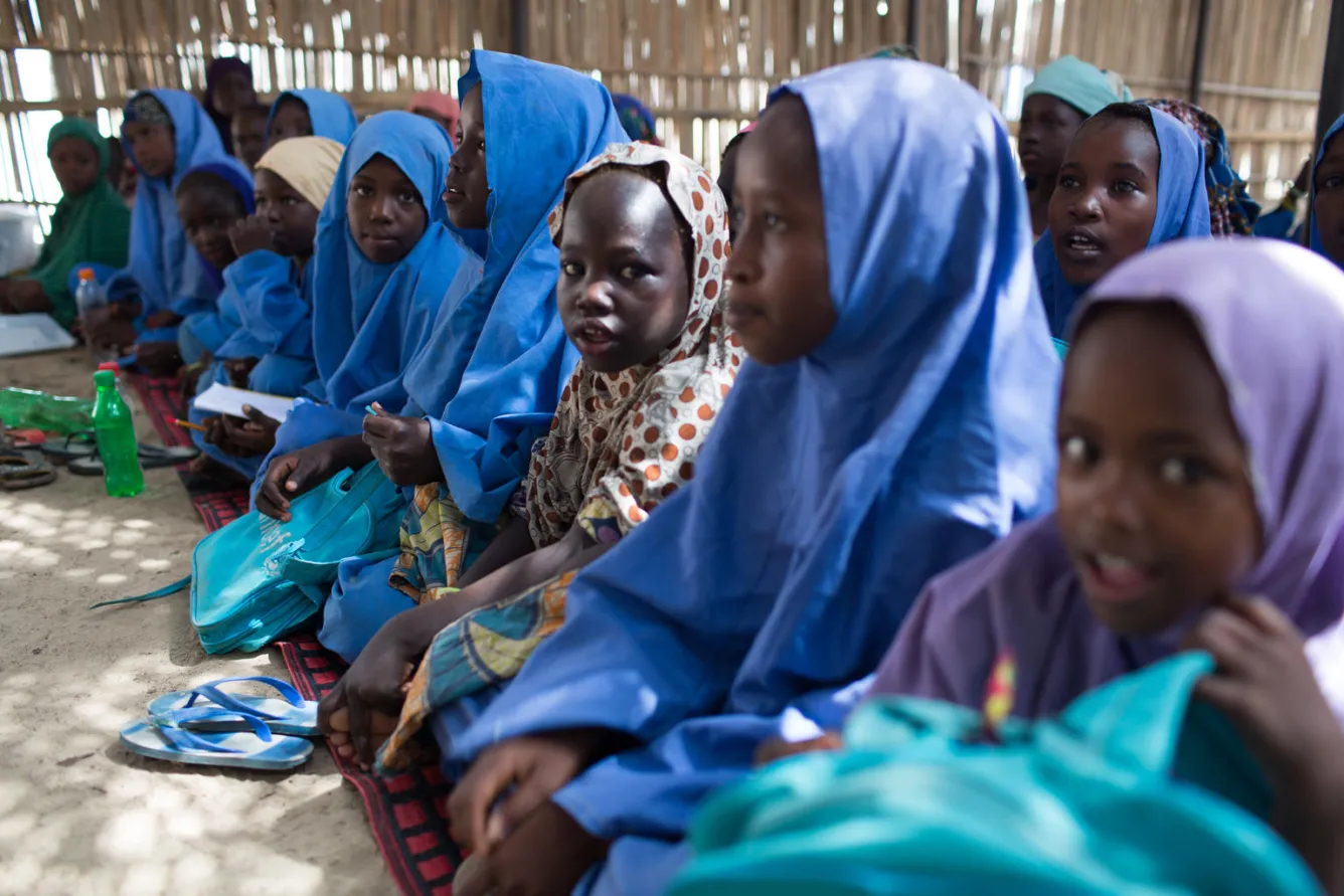 Children attend class in a temporary learning space in Muna Garage IDP camp