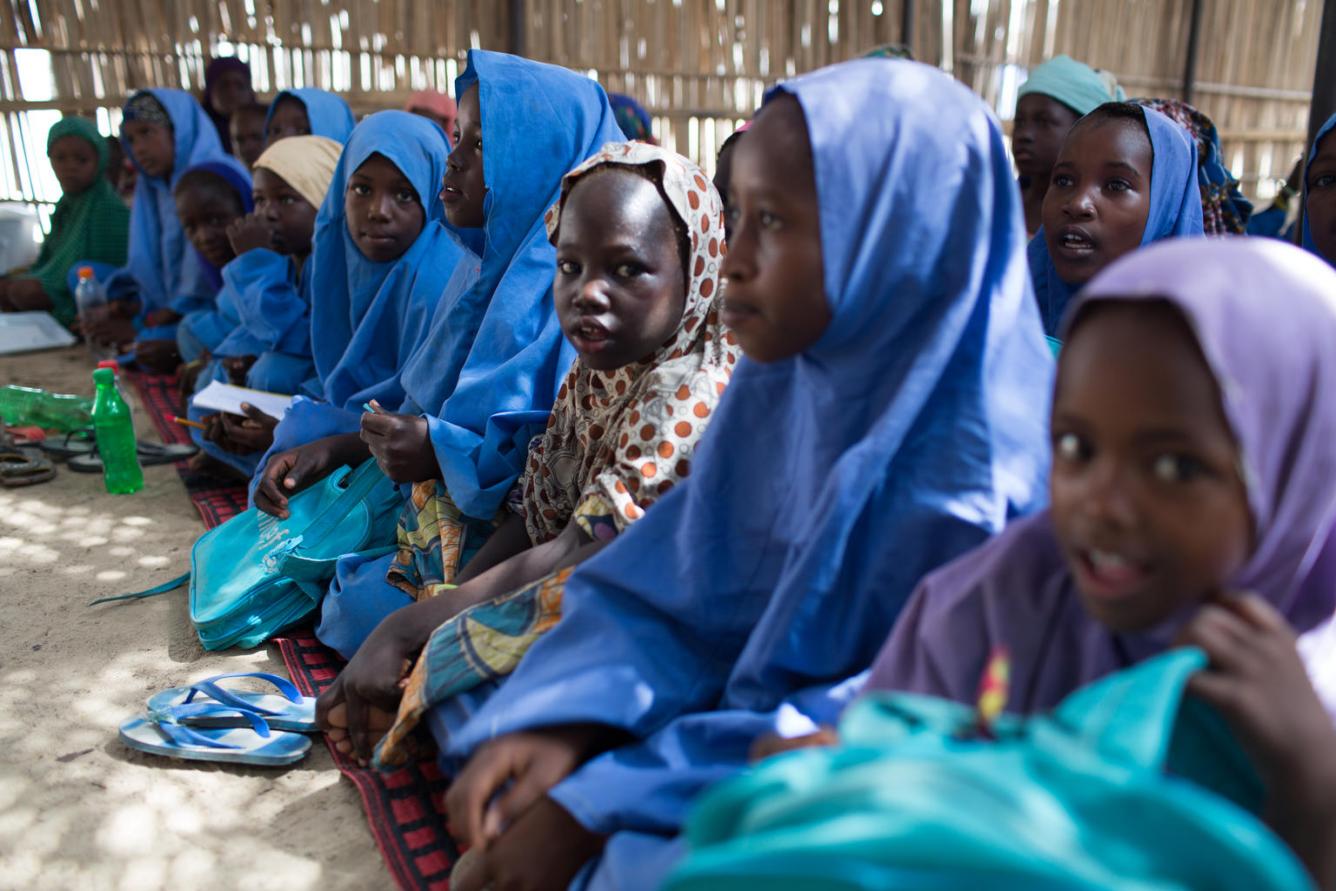 Children attend class in a temporary learning space in Muna Garage IDP camp