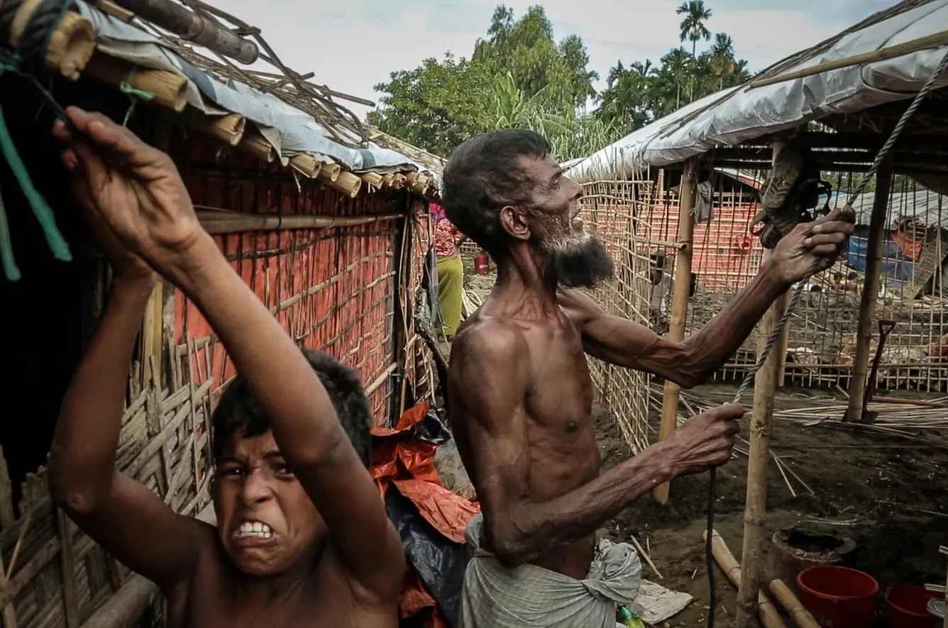 rohingya refugees securing makeshift shelters in Bangladesh