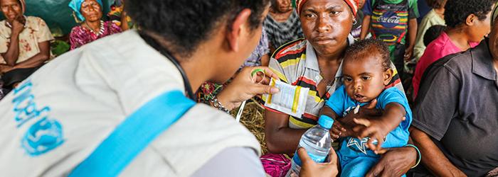 Aid worker helping child