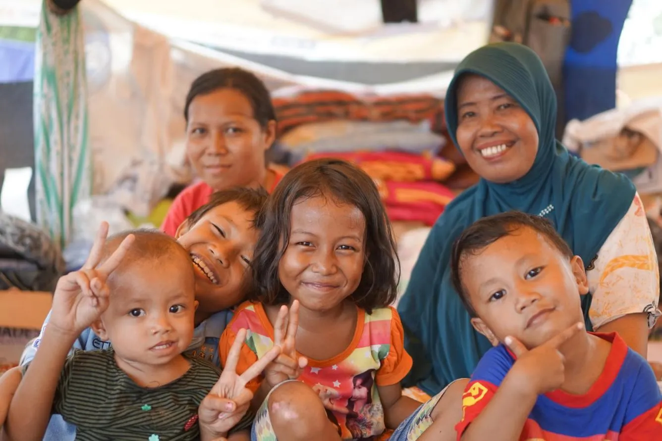 Family poses in temporary shelter