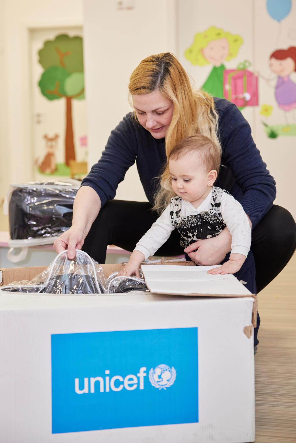 Mother and daughter opening UNICEF bag