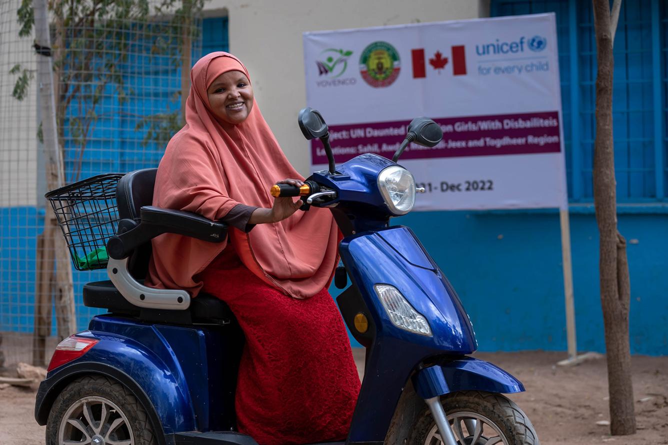 Young girl with a physical disability on her bike in front of her school in Puntland, Somalia.