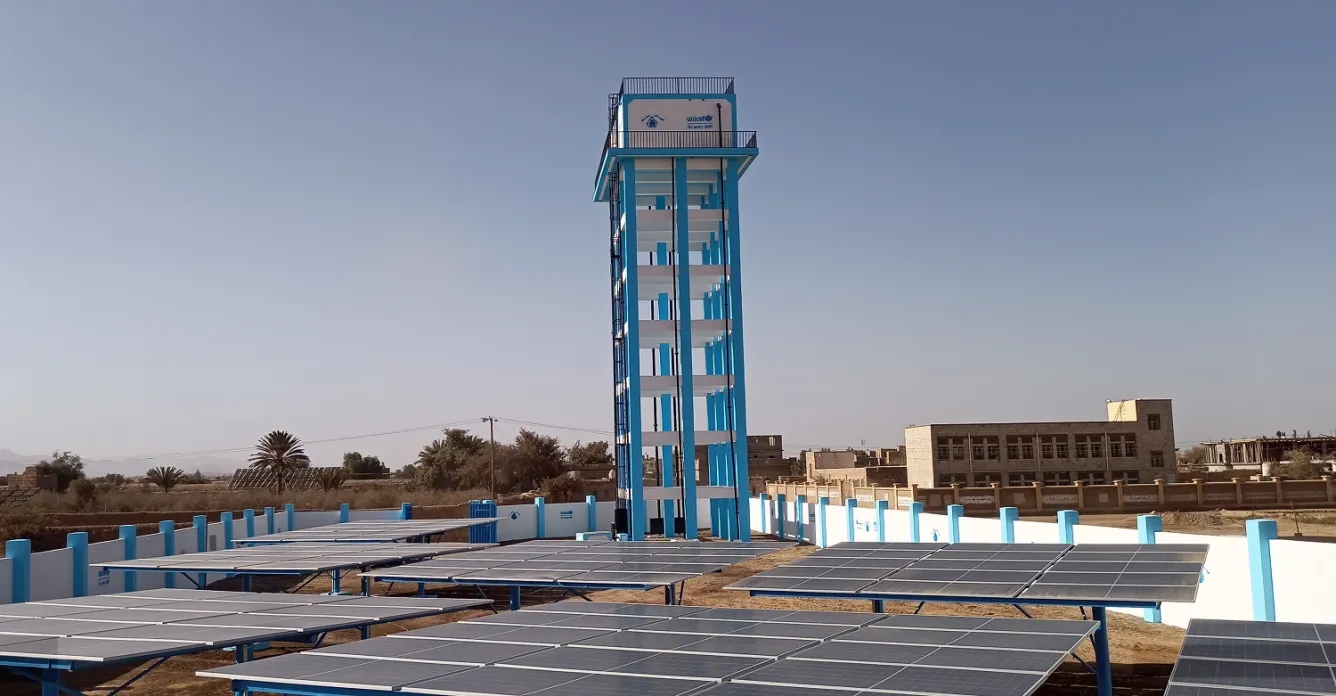 A solar-powered water system featuring a tower tank and solar panels in Yemen.