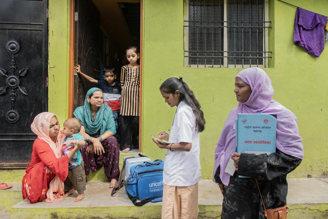 Health worker prepares to give a dose of Measles-Rubella vaccine to 12-month-old Arman during a door-to-door outreach session in Aurangabad, India.