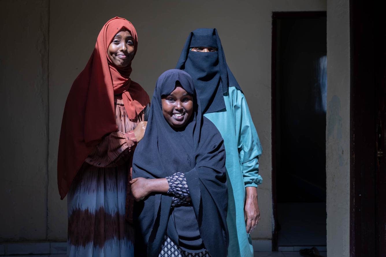 Saharla 13, poses for a portrait with her older sister Sondos, 19, and mother Fihima in the family home in Borana, Somaliland.