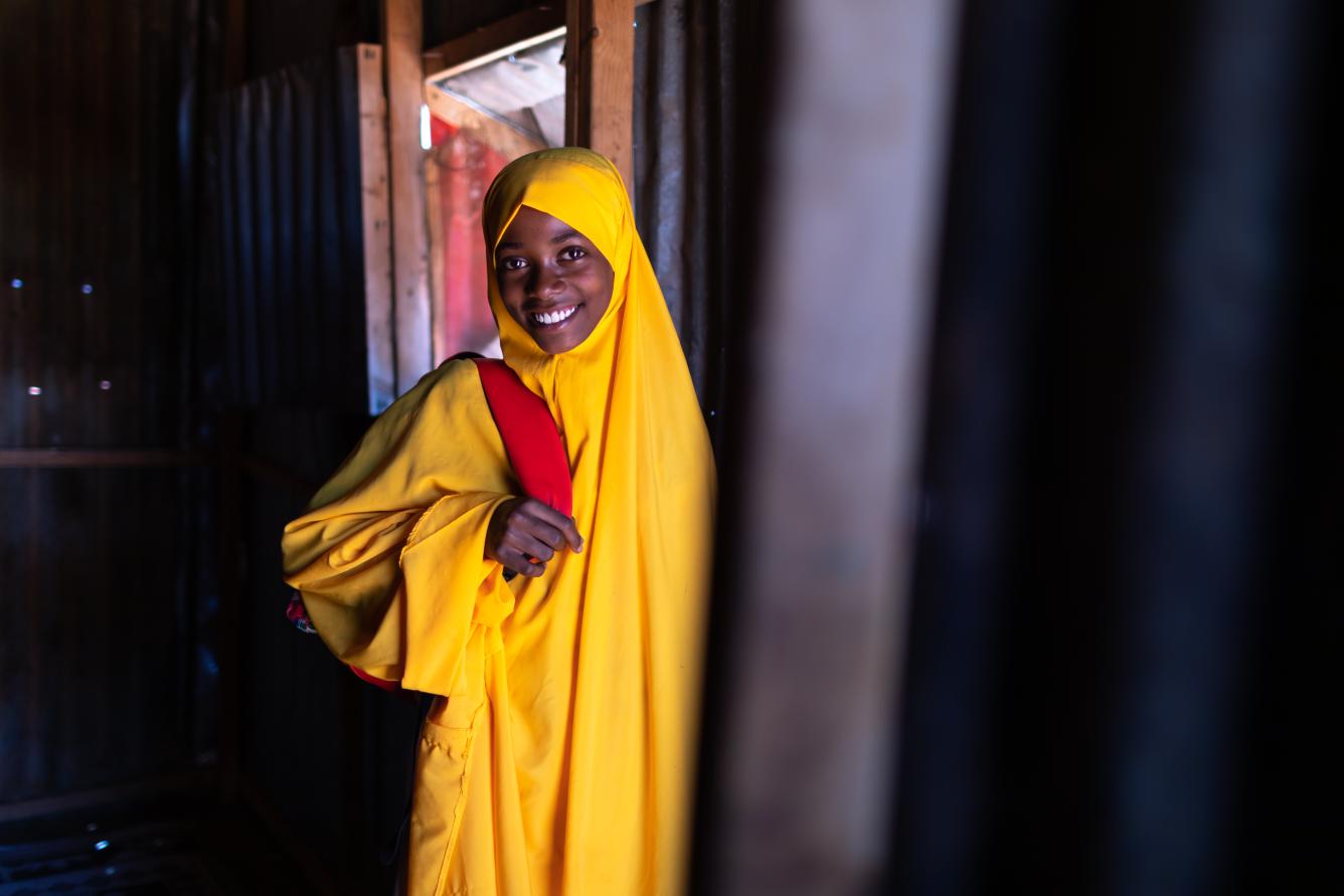 Hawa dresses in her bright yellow hijab school uniform before her half-hour walk to Mustaqbal School where she is a student.