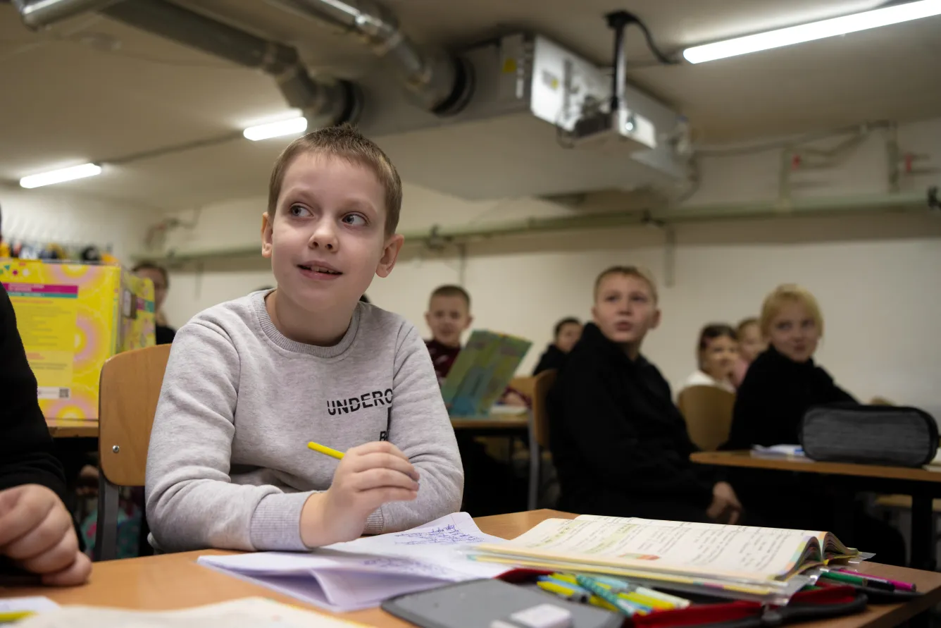 A boy looks on during his lessons in a basement-turned-classroom at a local school.