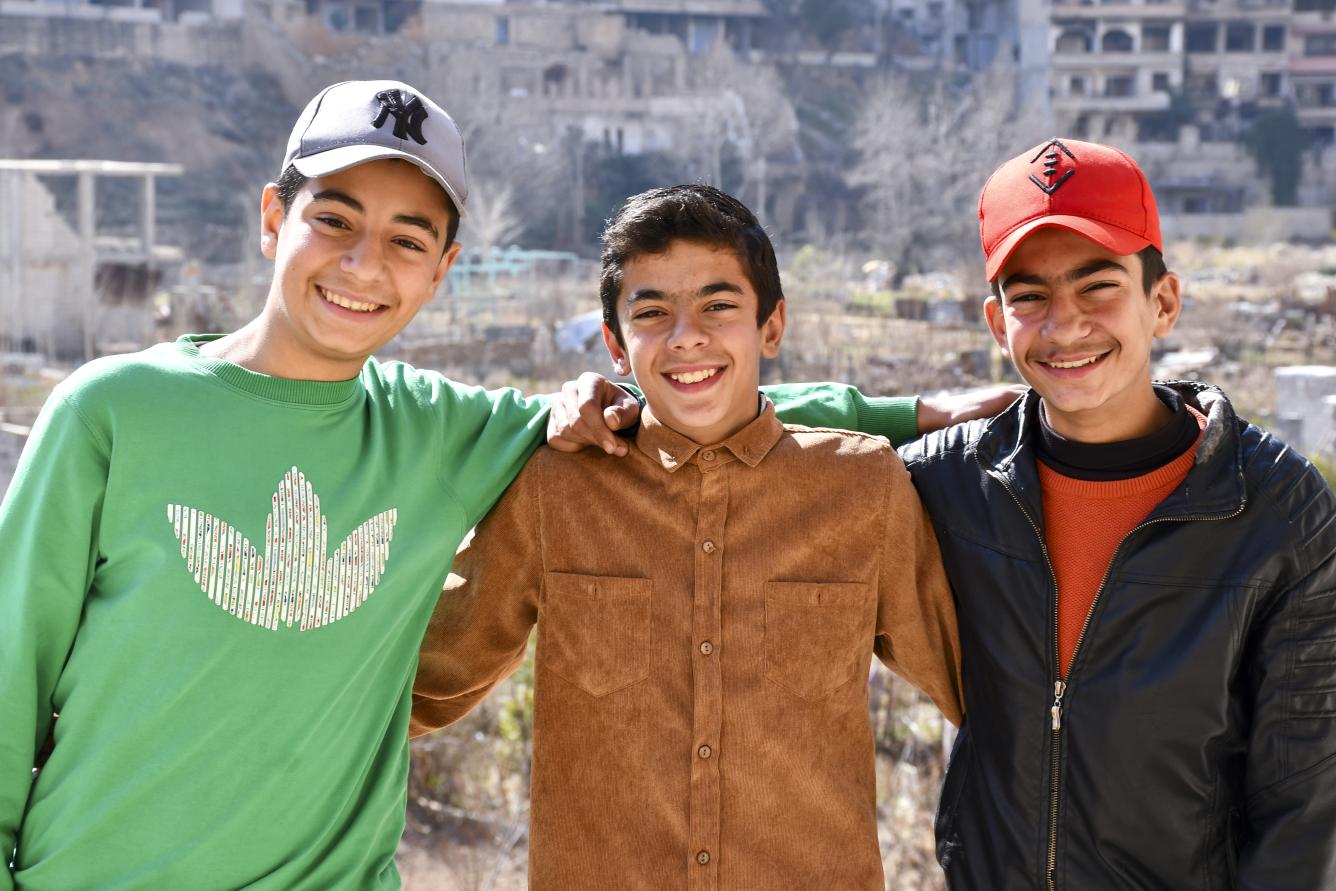 Mohammed, 15, with his two friends in Bseimeh village, Rural Damascus.