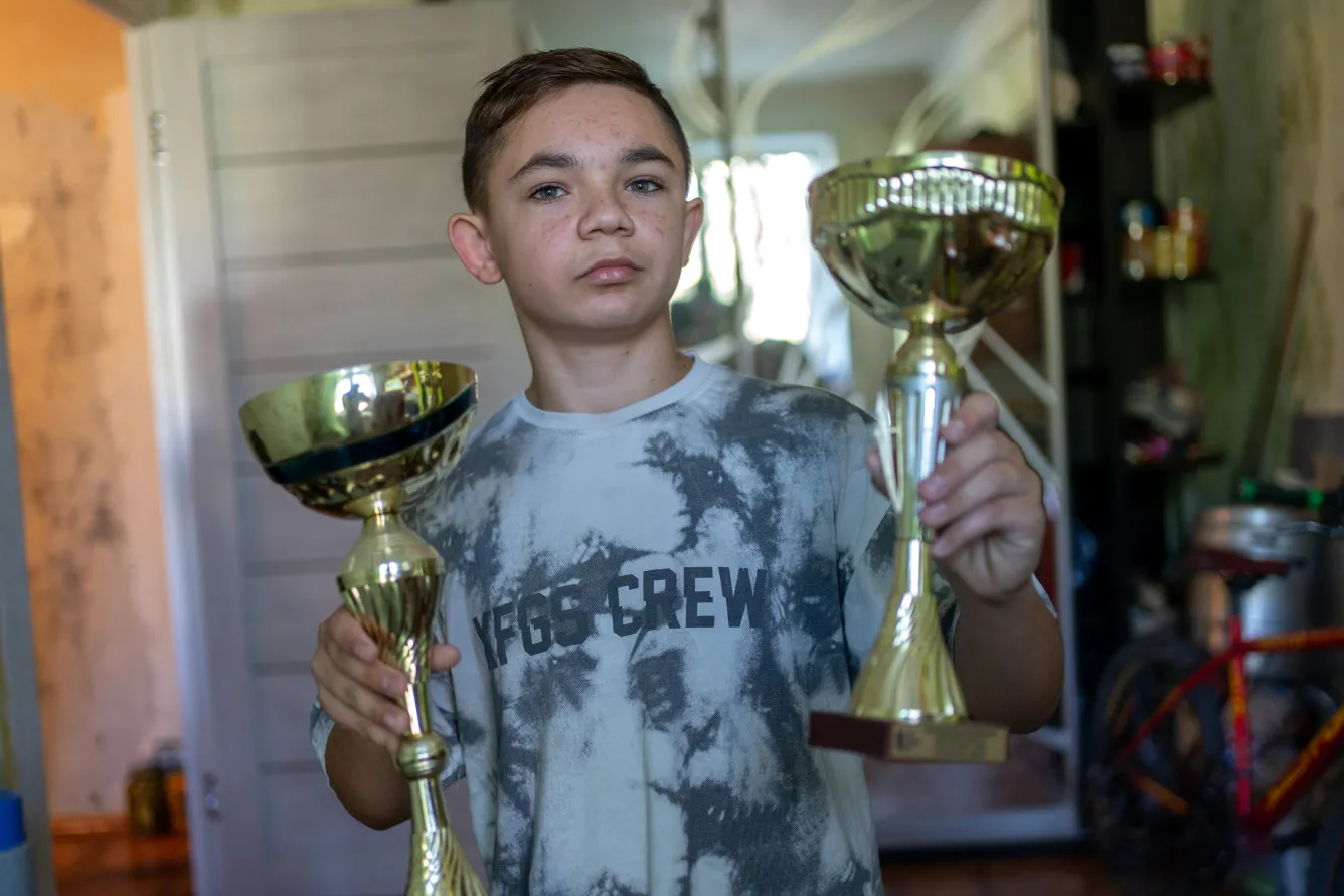 13-year-old Bohdan shows his trophies for the dancing competitions.