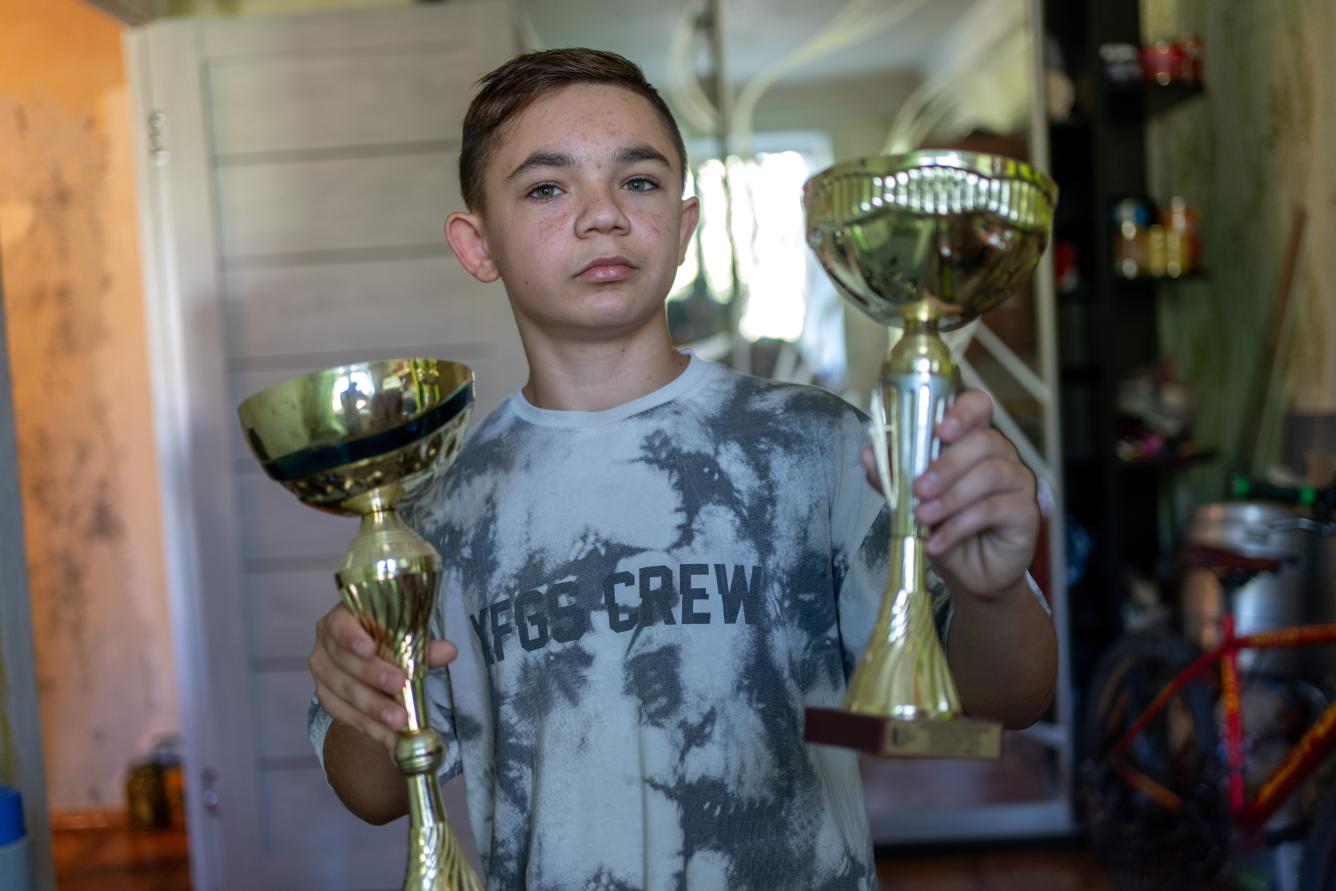 13-year-old Bohdan shows his trophies for the dancing competitions.