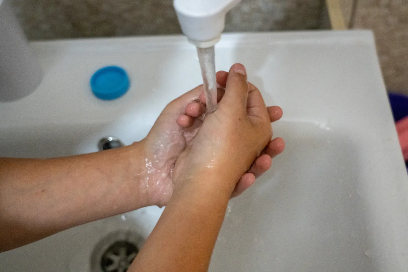 13-year-old Bohdan is washing his hands.