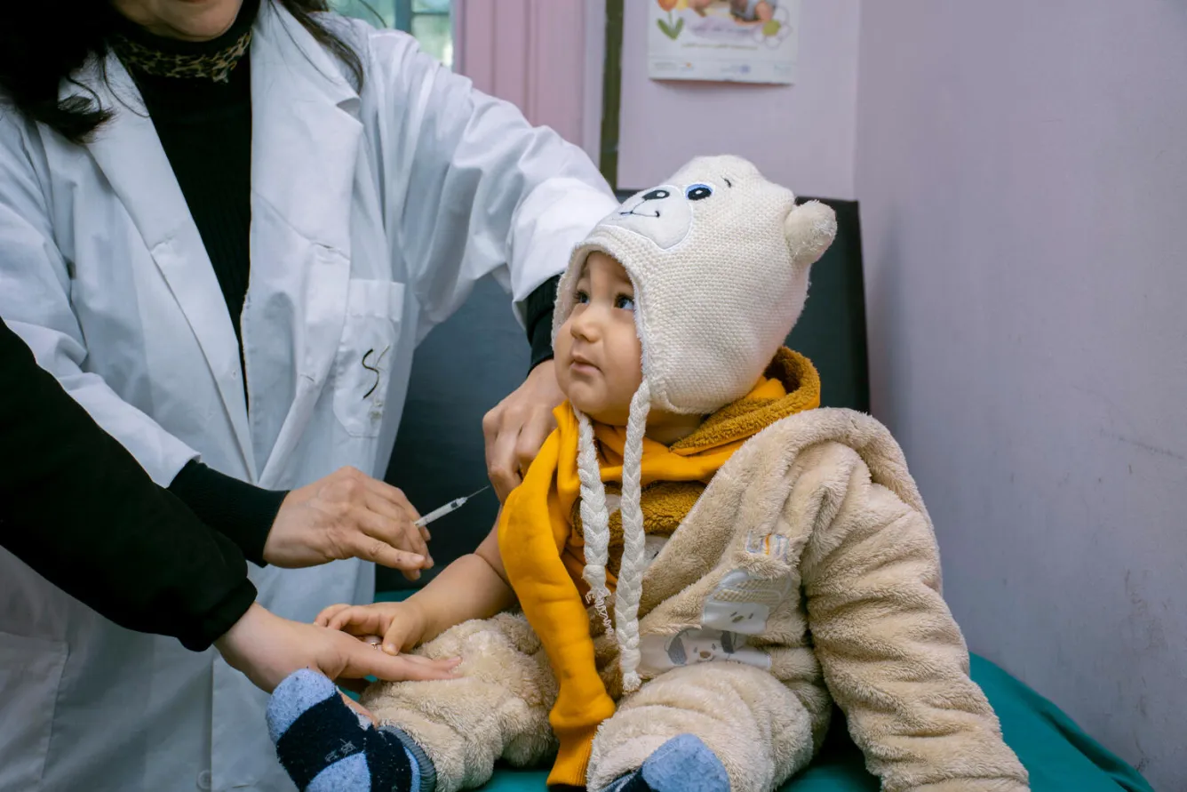 A baby gets vaccinated in a clinic.