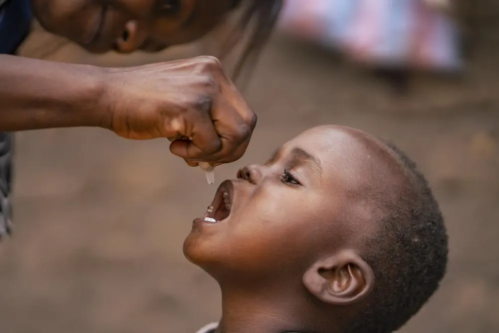 A child receives an oral polio vaccine.