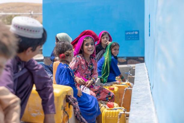 Children collect water from a UNICEF-supported tap in Badghis Province, Afghanistan.