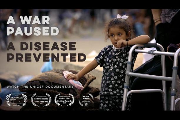 Film title page with image of a young girl standing with her elbow resting on a mobility device beside a stack of belongings, with the overlaid text A War Paused, A Disease Prevented: Watch the UNICEF documentary.