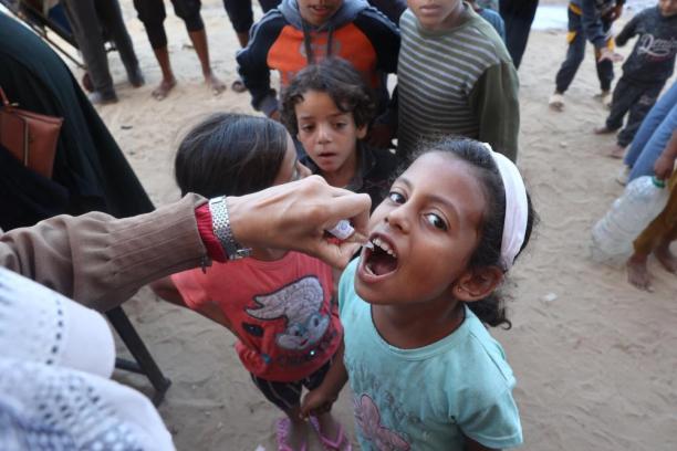 A child receives the oral polio vaccine. 