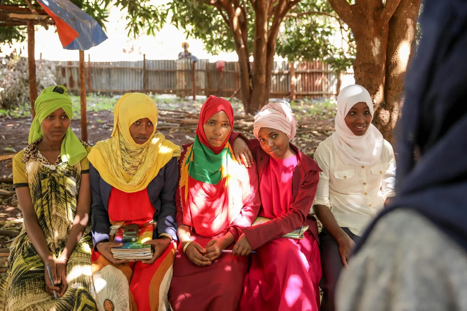 Girls pose together outside their school in Ethiopia.