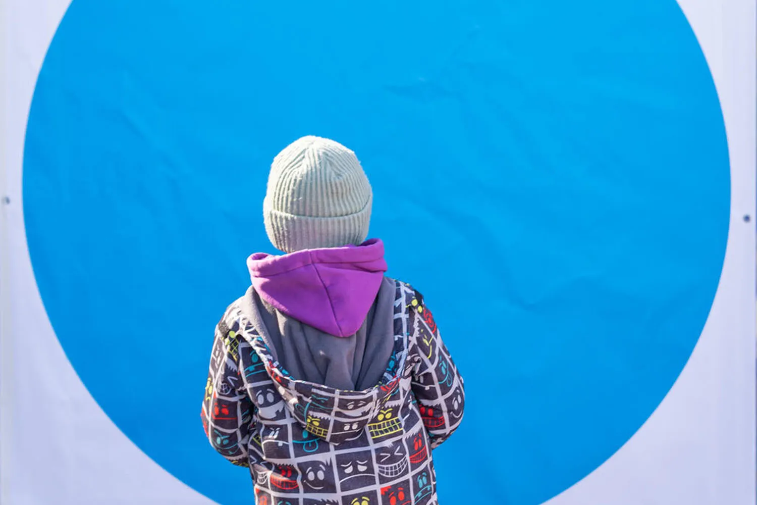 A child standing at a Blue Dot hub