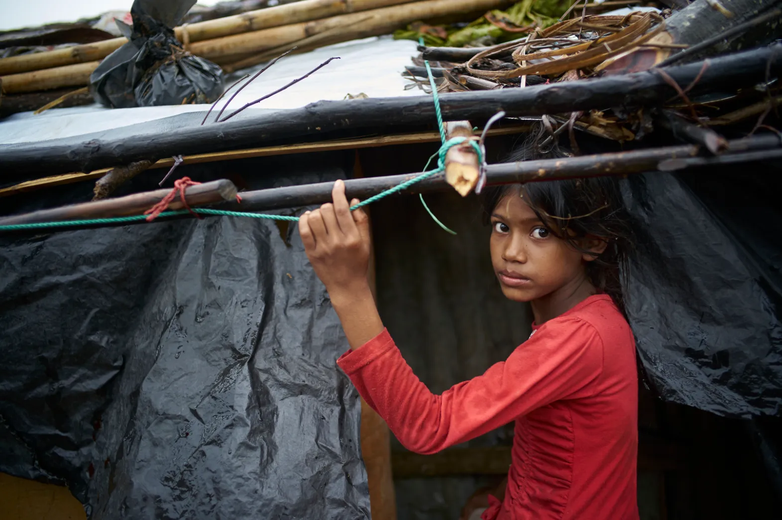 Young girl under shelter bracing for Cyclone Amphan