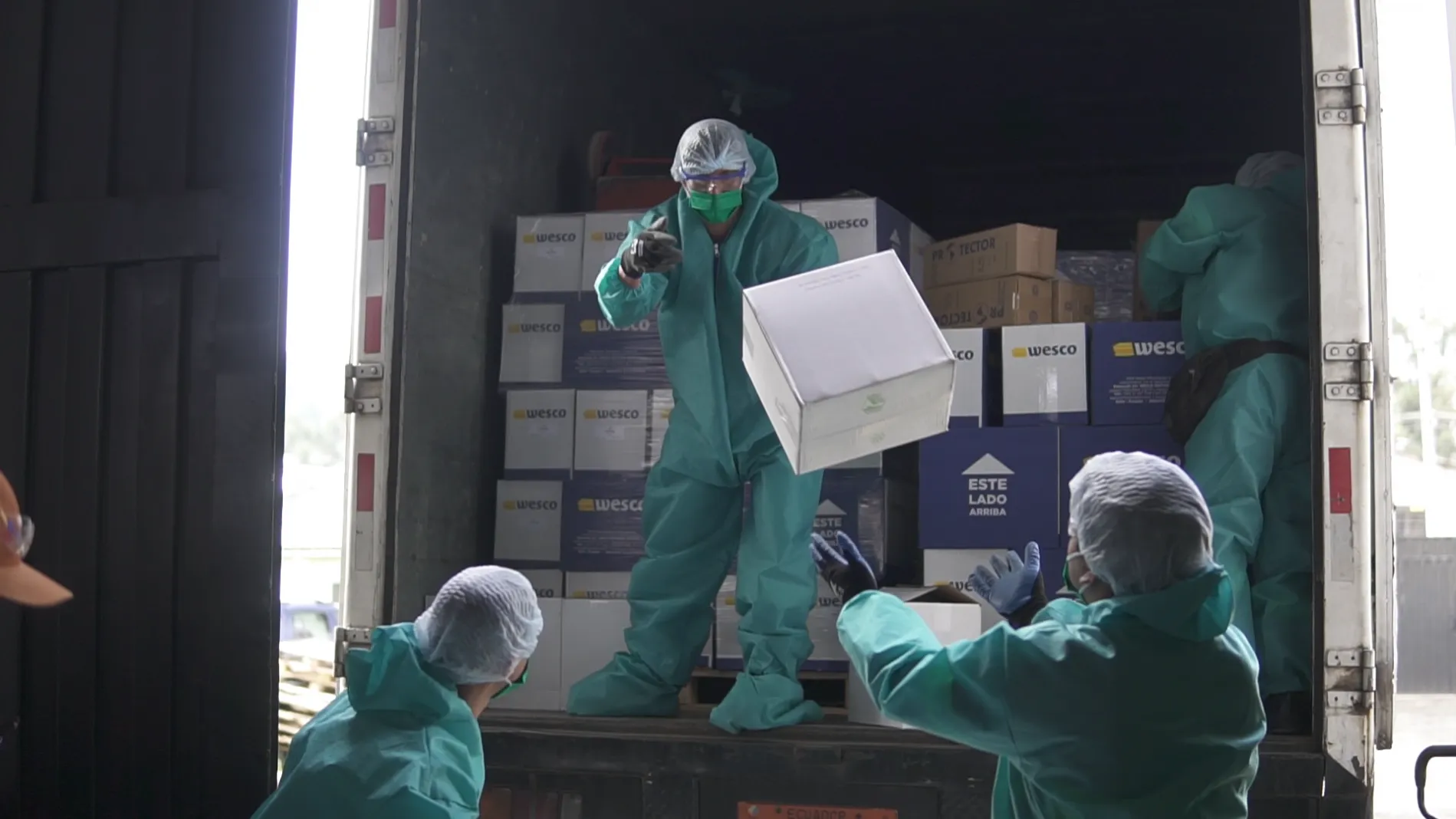 Workers unload medical supplies in Ecuador.