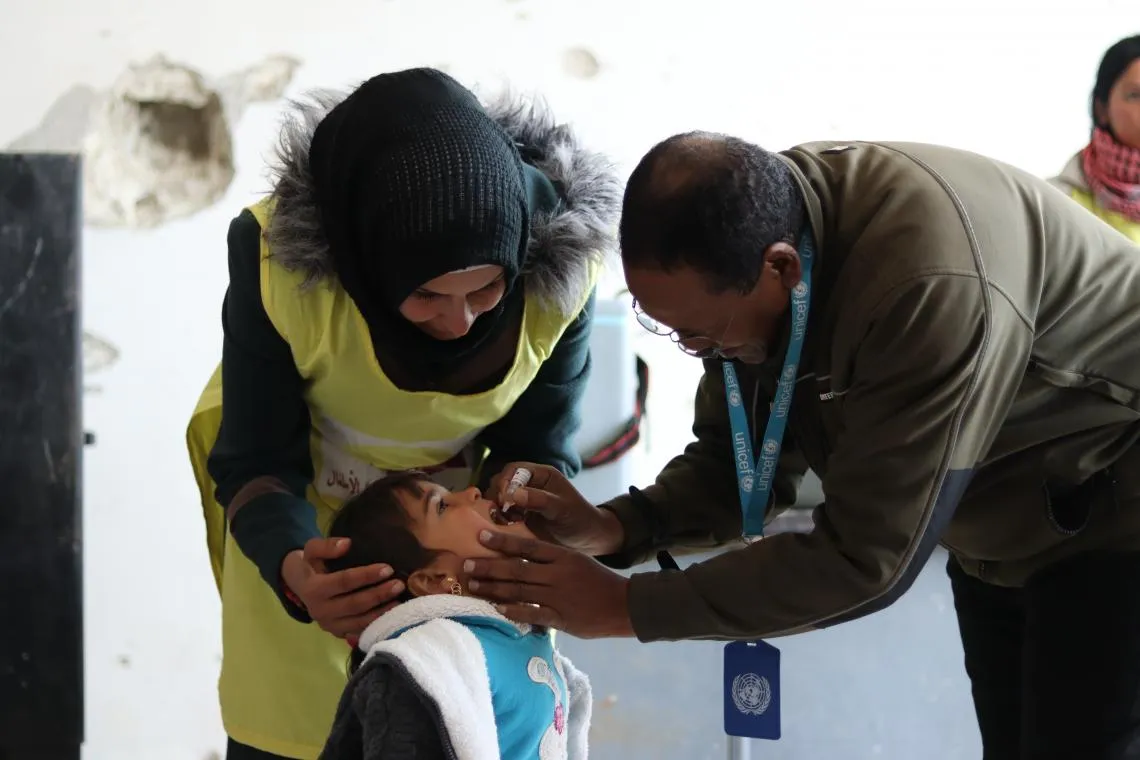 A child receives an oral vaccination.