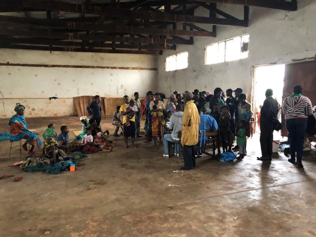 People wait at a temporary shelter in Gondola, Mozambique.