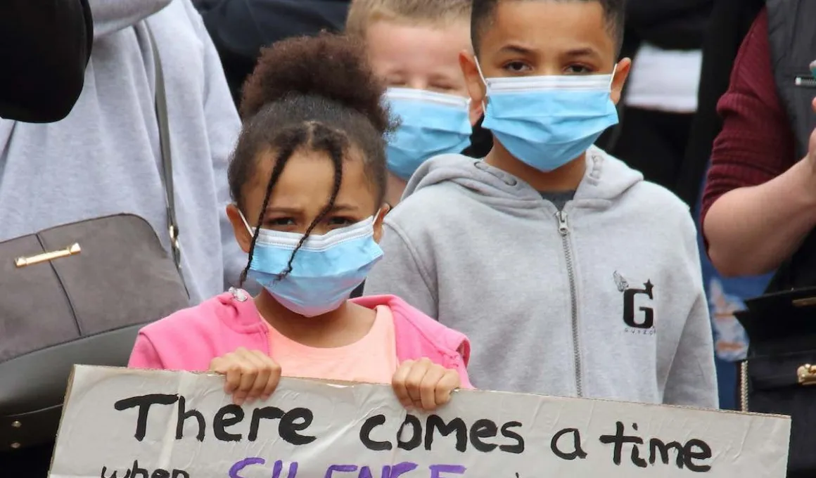 Two children hold a sign at a Black Lives Matter protest.