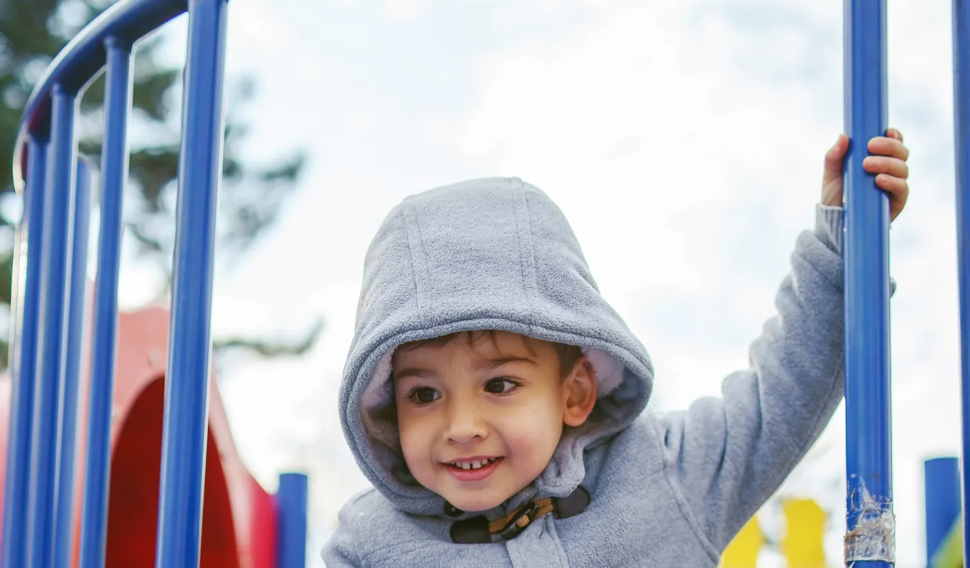A boy playing at a playground.