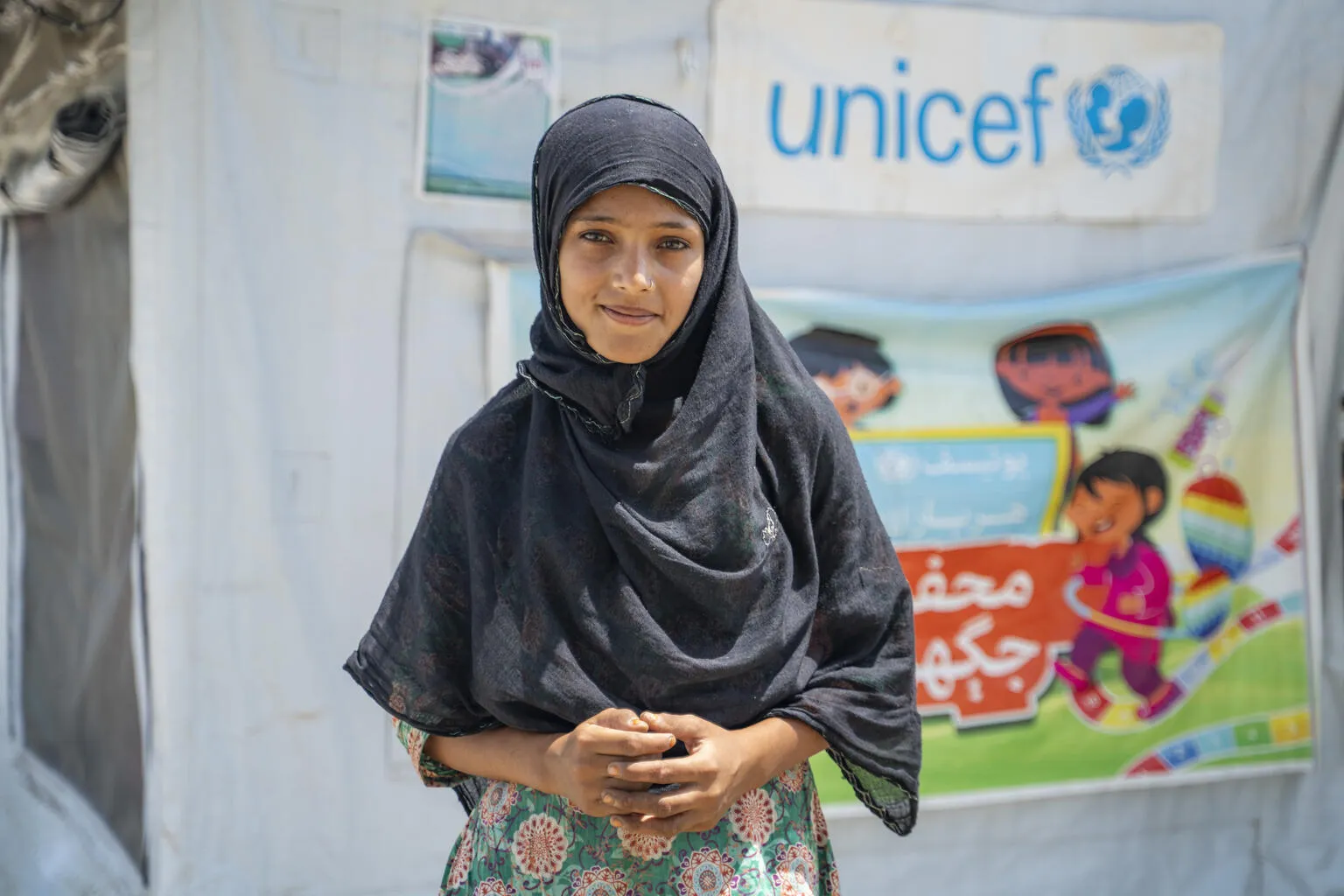 Une fille se tient à l’extérieur d’un espace adapté aux enfants soutenu par l’UNICEF dans la province du Sindh, au Pakistan. 