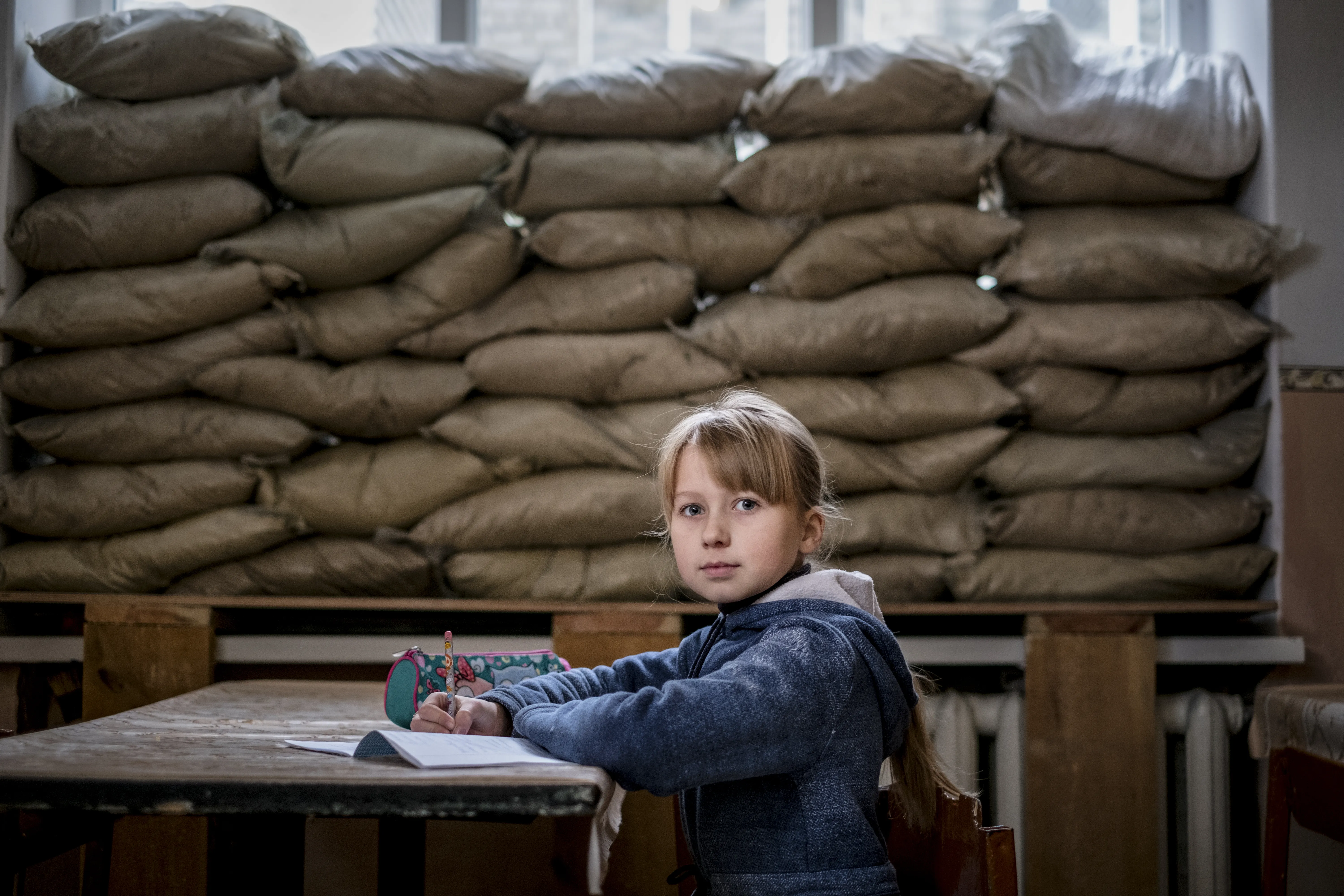 Lera Nagormay, 10, sits for a photograph in a classroom at school in Marinka, Donetsk Oblast, Ukraine.