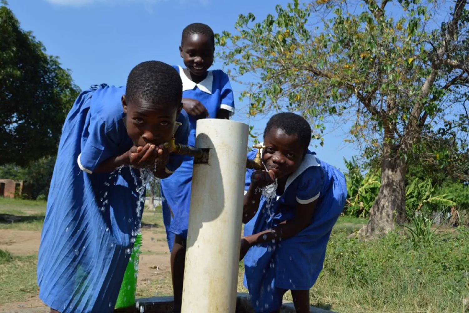 Girls drinking water in Malawi