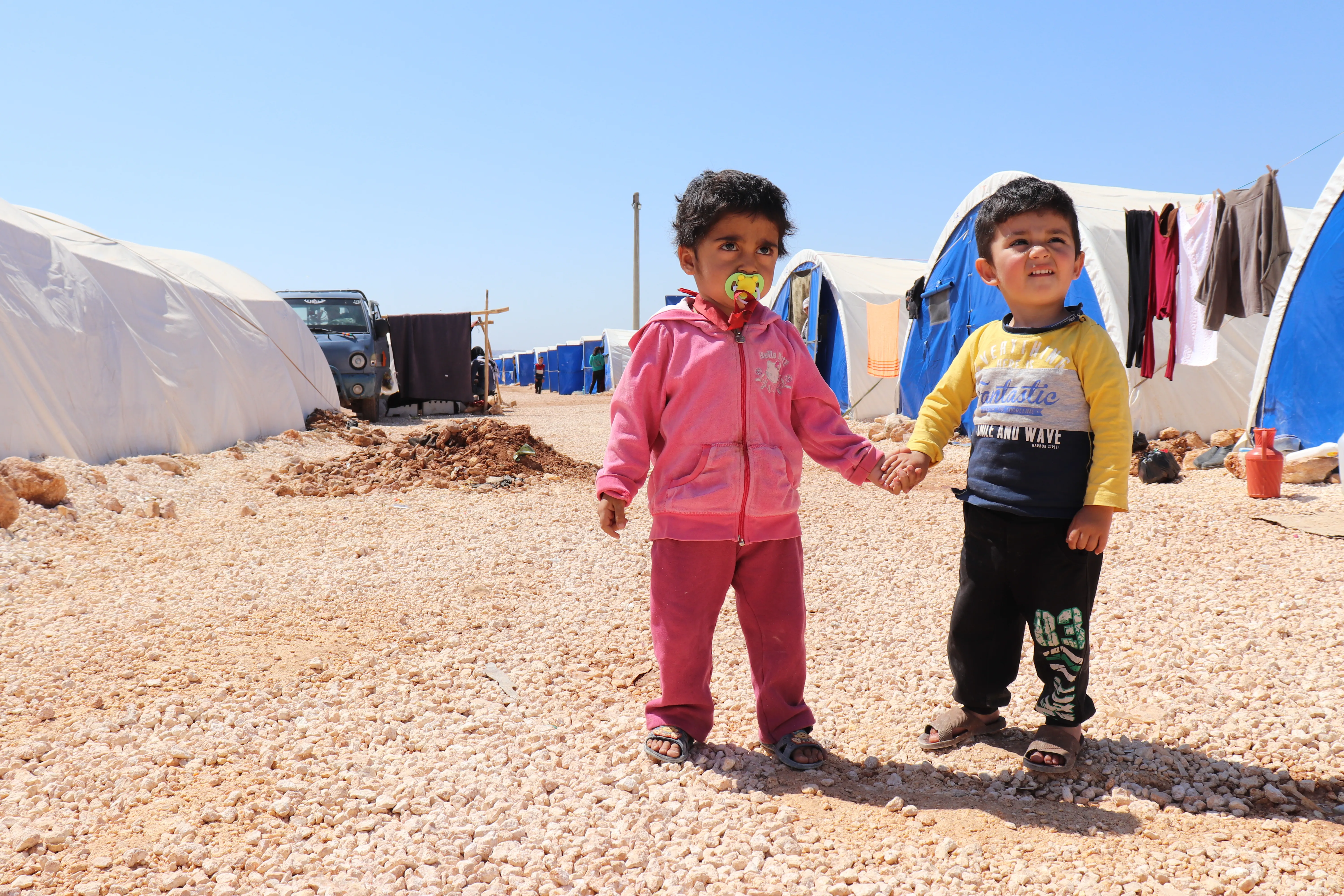 Children holding hands, Syria, 2018.