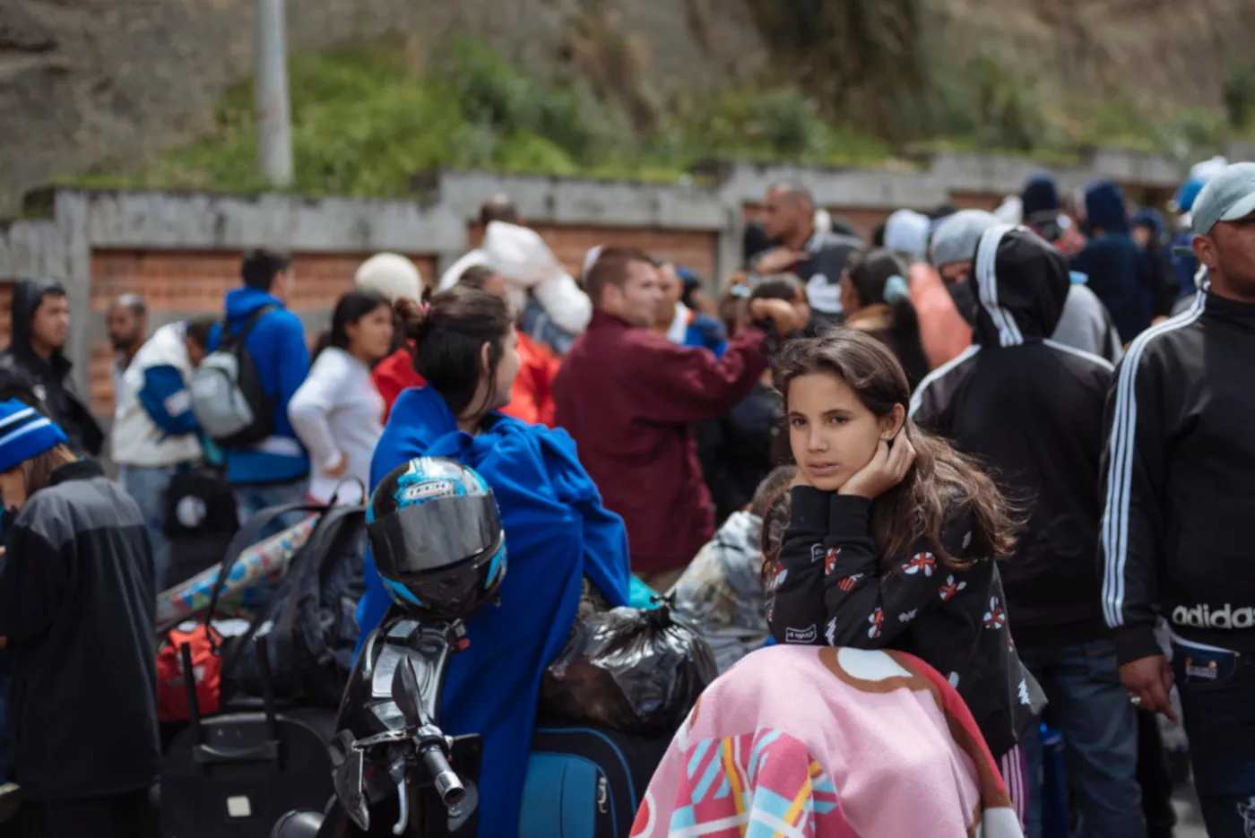 A migrant girl waits for processing