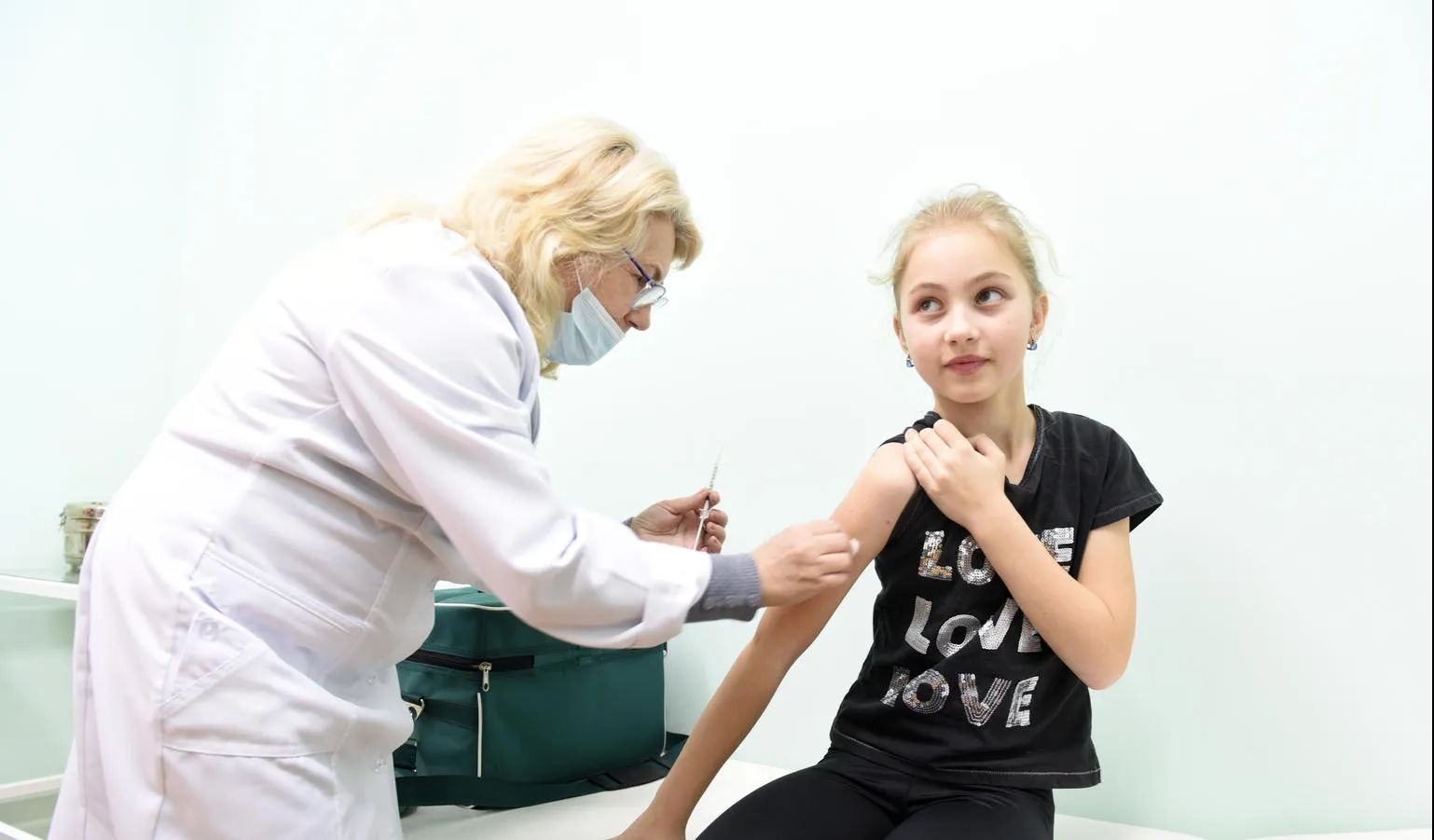 girl receives vaccination in Ukraine
