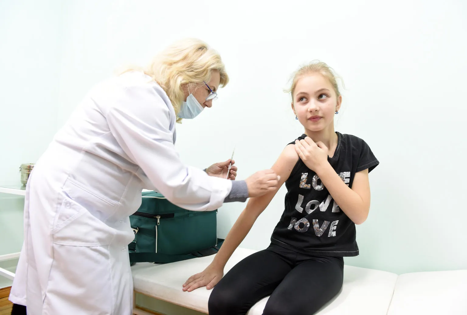 A young girl receives an MMR vaccine.