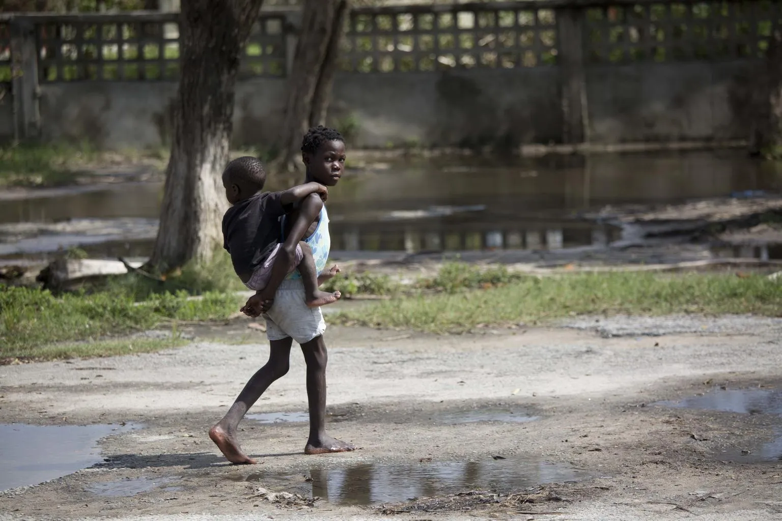 girl holds boy on her back