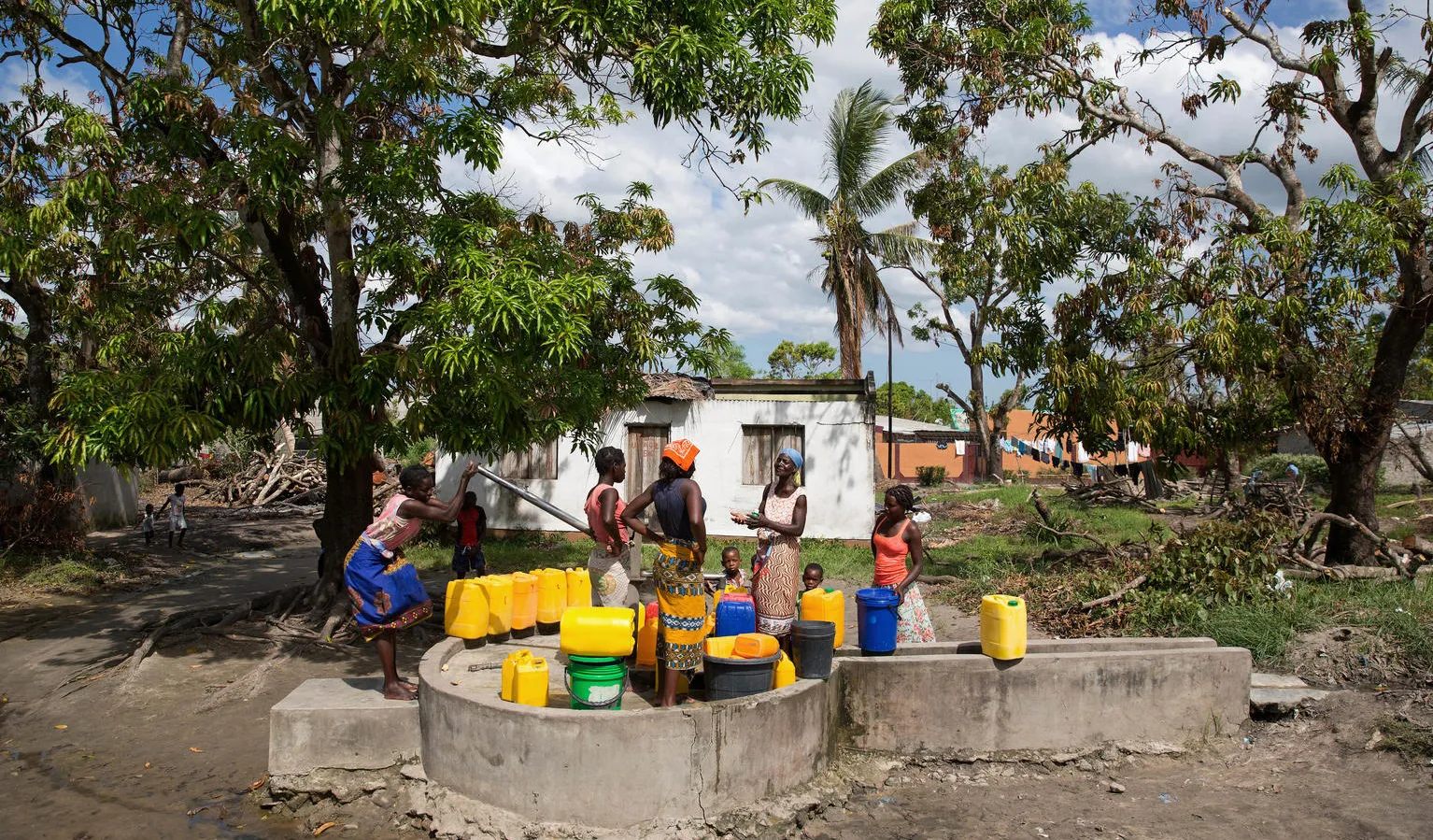 A woman fill jerricans at a community water point. 