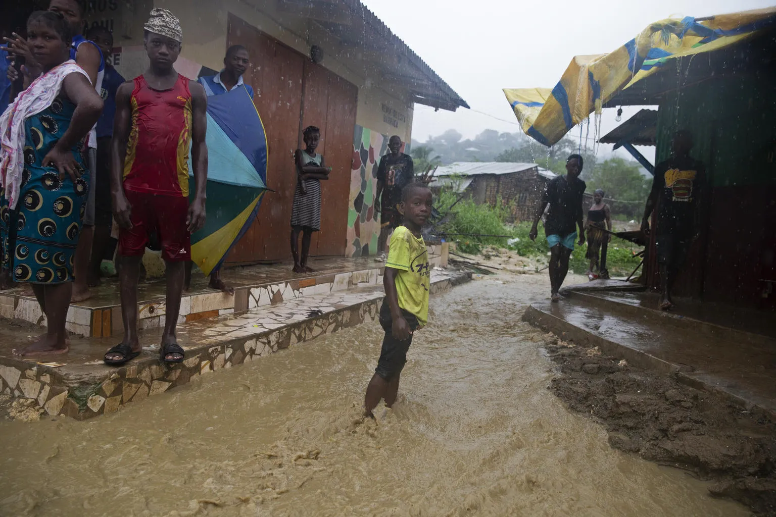 Boy stands in flooded streets in Pemba, Mozambique