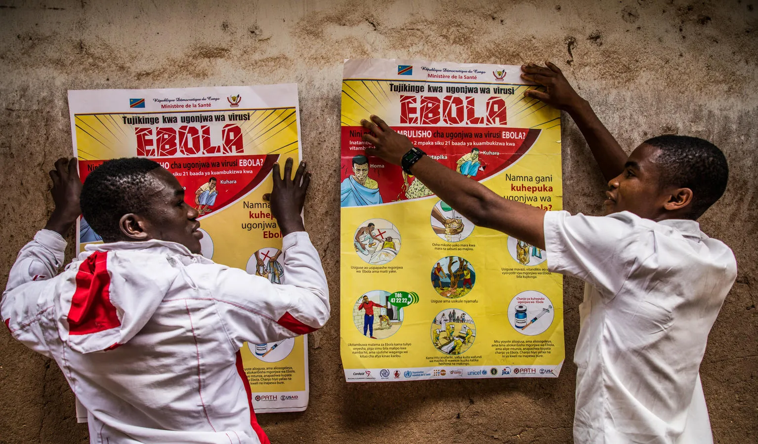School children put up posters with ebola advisories.