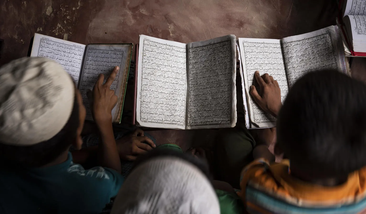 Boys study textbooks in a UNICEF learning centre.