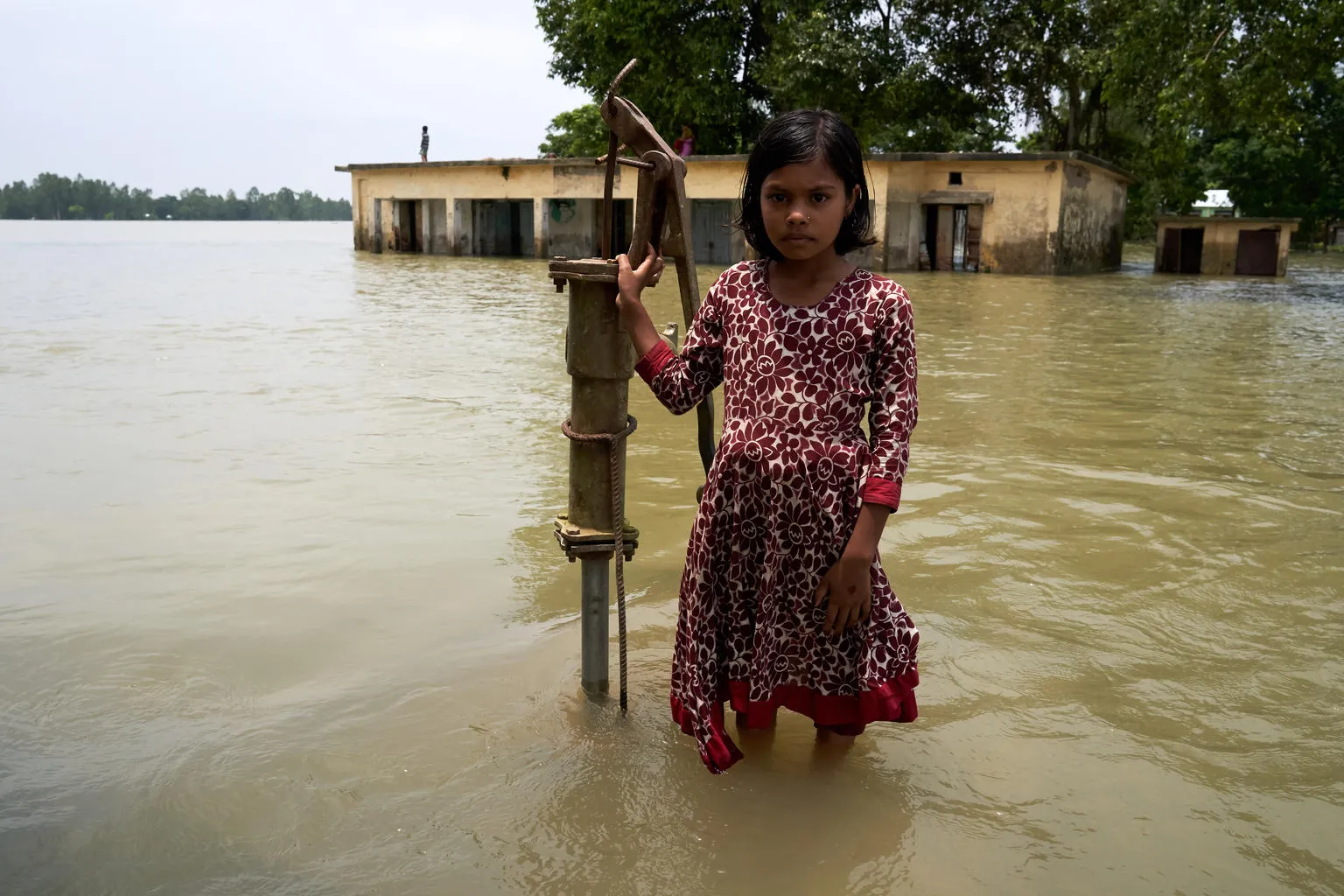 girl in front of her school in Bangladesh