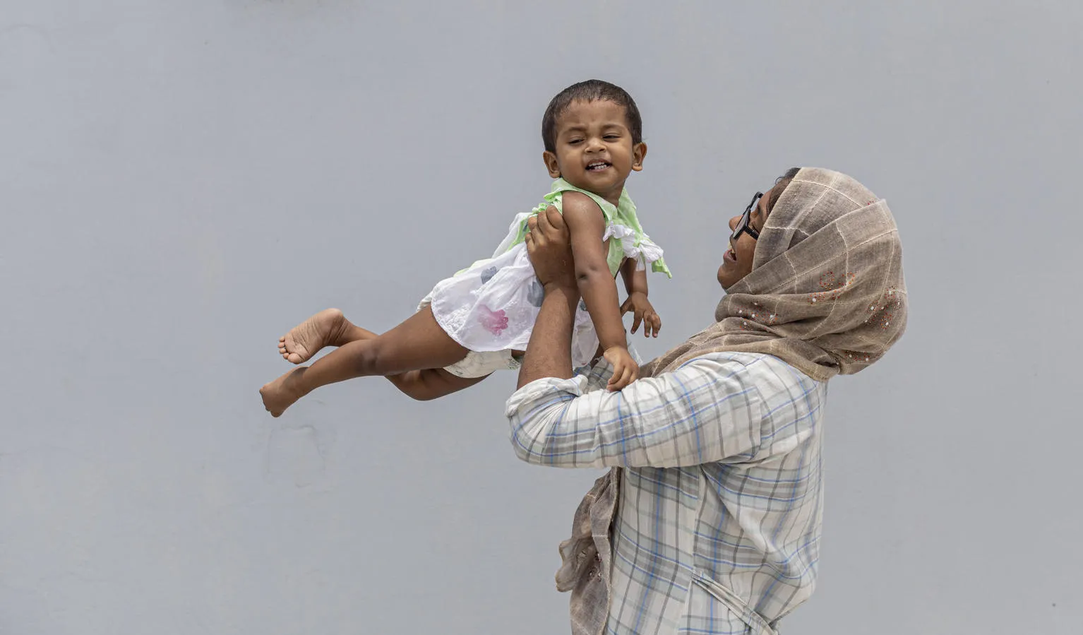 A mother holds her baby in India