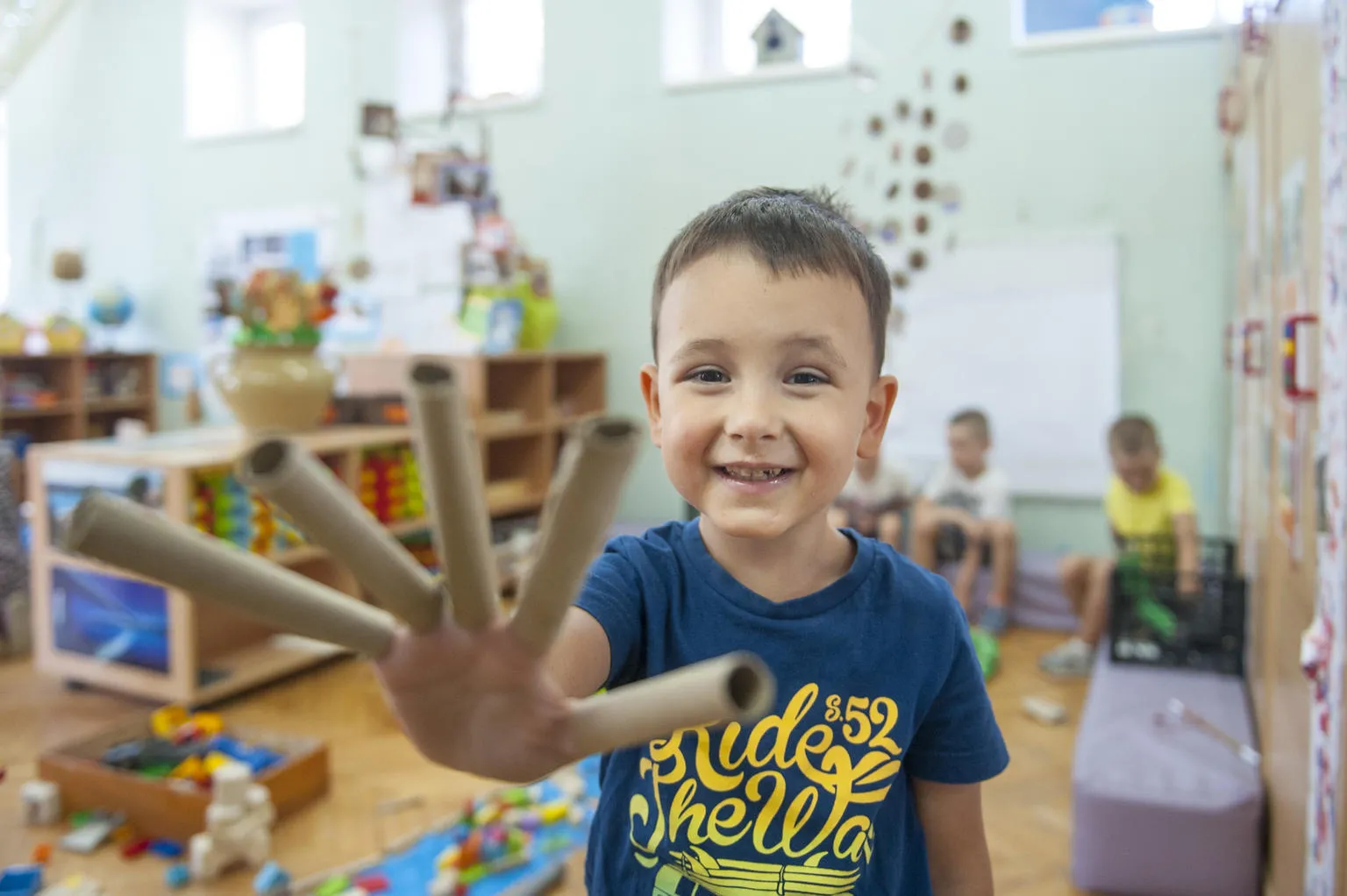 A young boy smiles and plays at his pre-school in Belgrade, Serbia. 