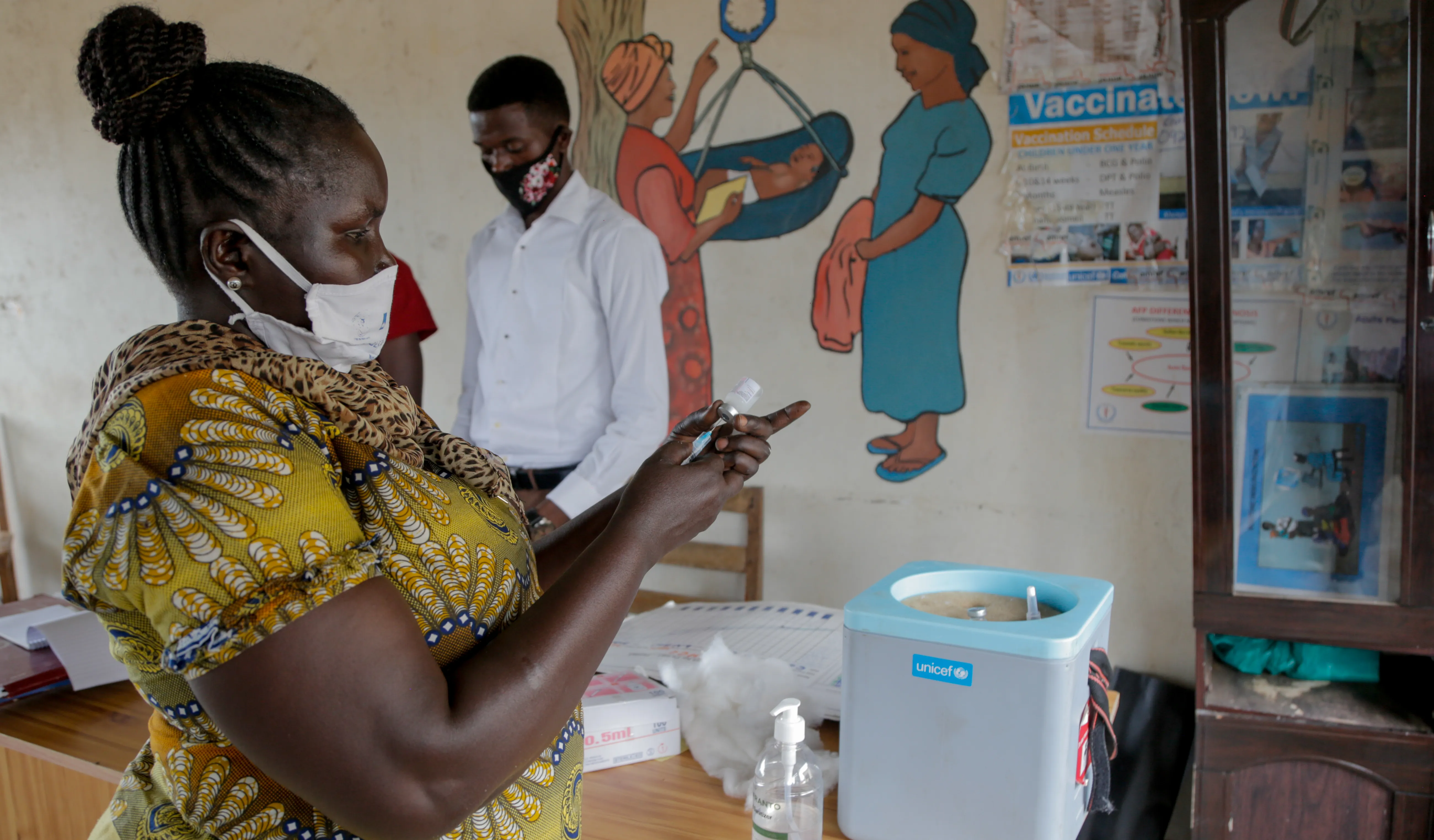 On 8 October 2020 at Gurei Health Care Centre in Juba, South Sudan, Elisabeth Abraham Loro, nurse and vaccinator, collects vaccines from a cold box.