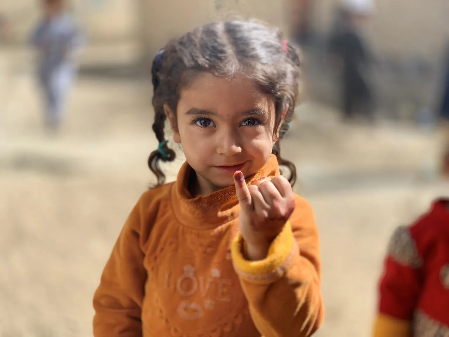 A child in Kandahar, Afghanistan shows her marked finger after being vaccinated against polio during the a vaccination campaign in September 2020 that targeted over 6 million children under five years of age. 