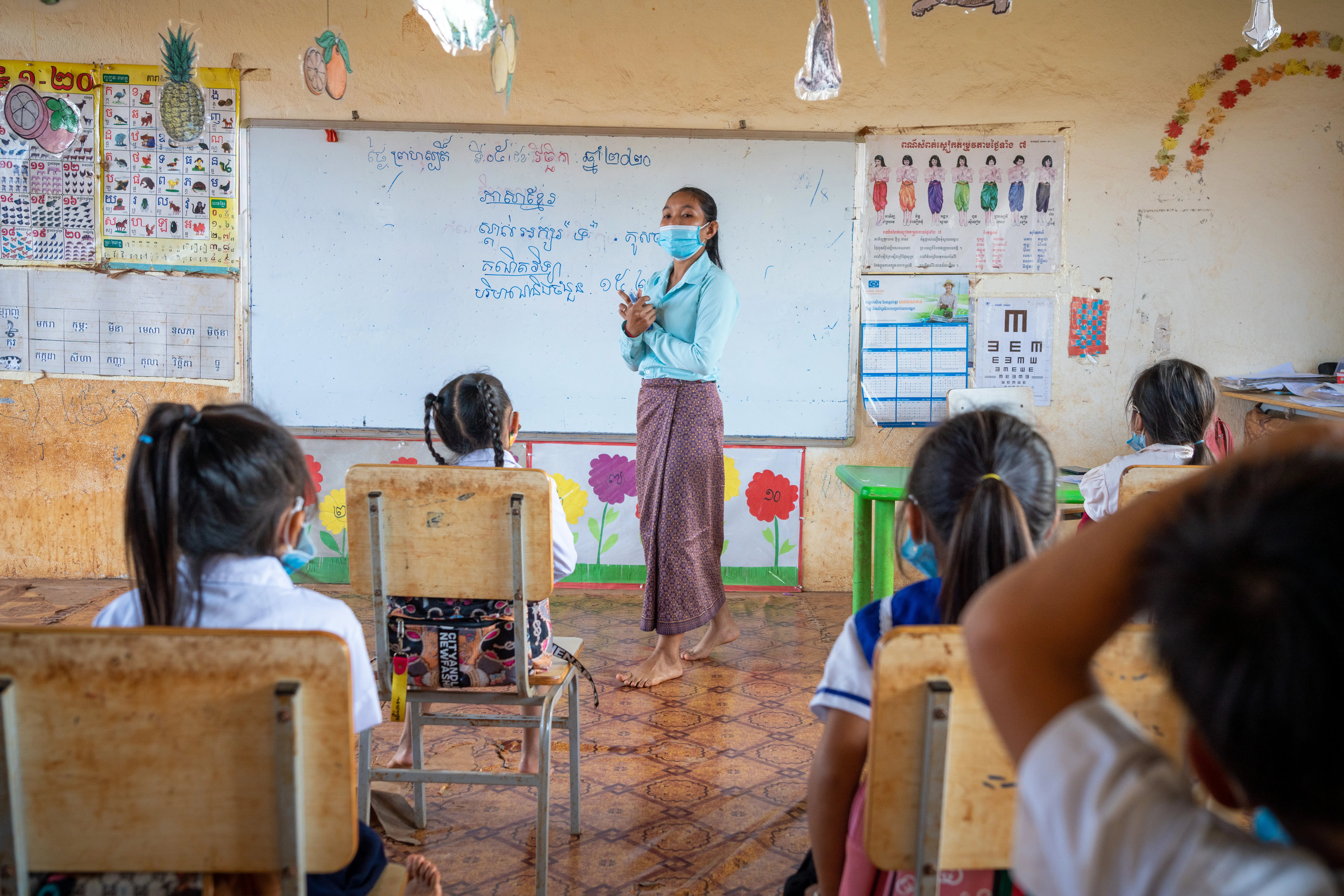 05 November 2020, Trom Village, Laminh Commune, Borkeo District, Rattanakiri, Cambodia. Portrait of MORN Sambo, 27, teacher at the village primary school of Trom, teaching a disabled student. 