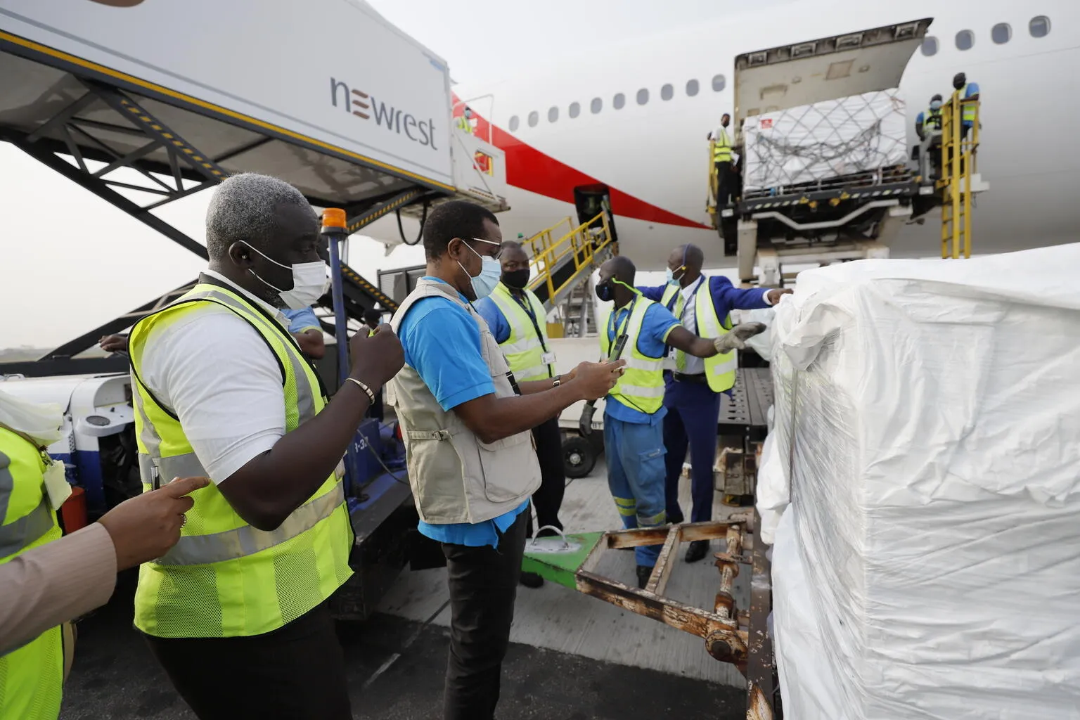 On 24 February 2021, staff unloads the first shipment of COVID-19 vaccines distributed by the COVAX Facility at the Kotoka International Airport in Accra, Ghana's capital.