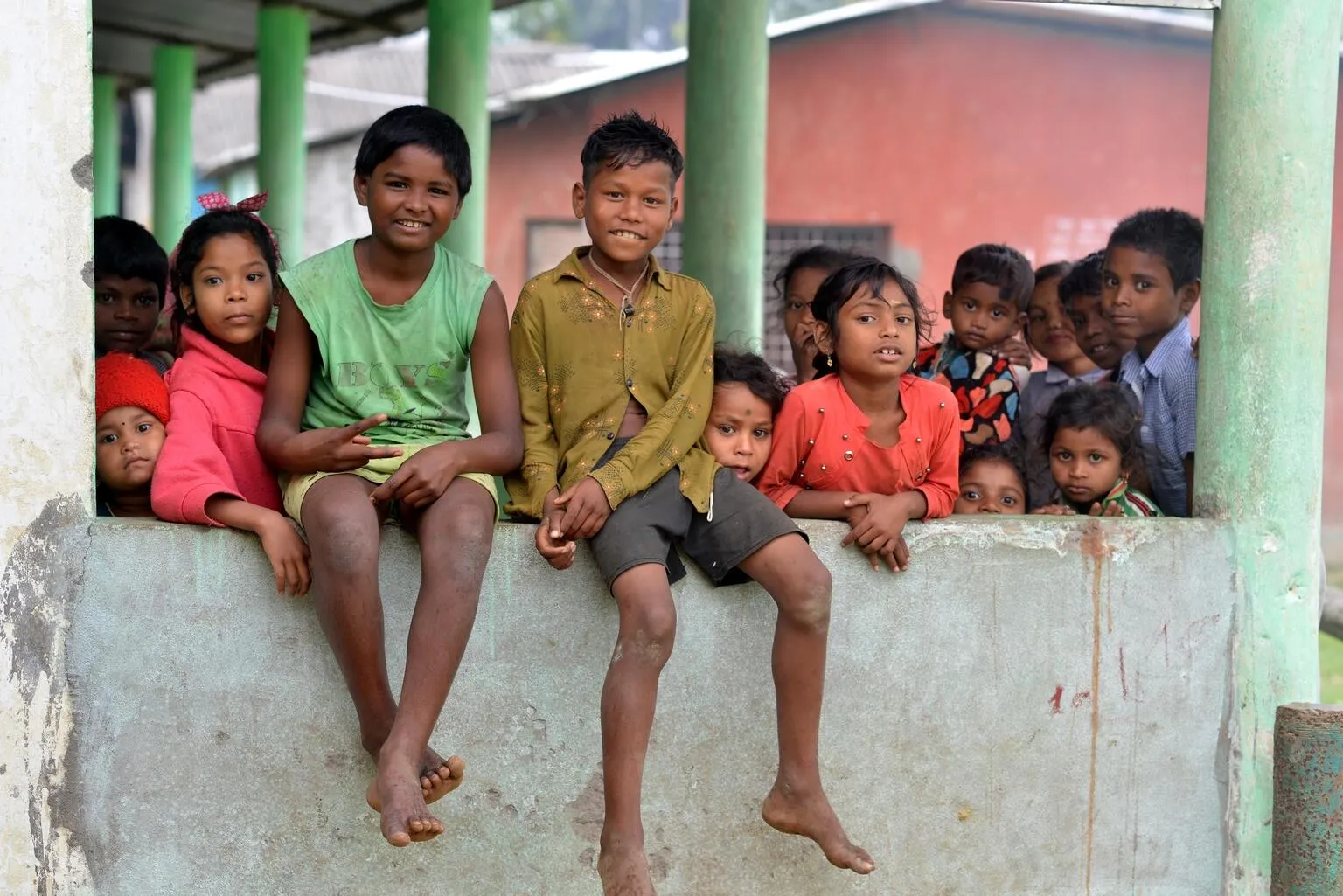 Children pose for a photograph at Mahabirbari Tea estate in Dibrughar district of Assam.