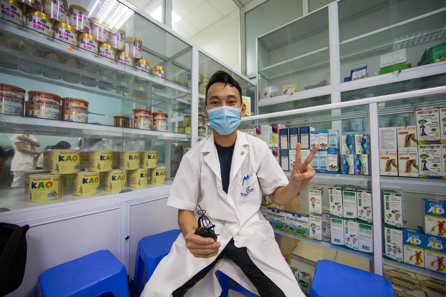 A health worker gives the 'V for Vaccinated' sign at a hospital in Vietnam.